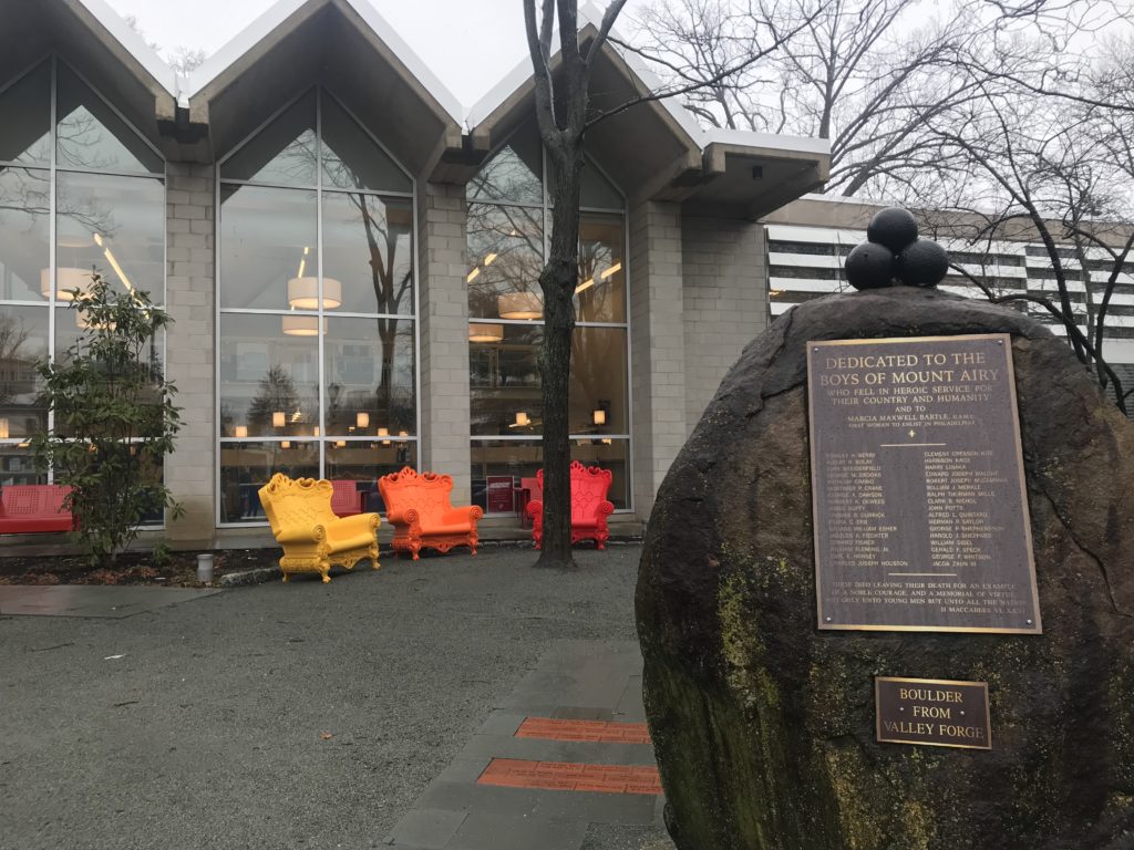 Large boulder with plaque placed in front of library