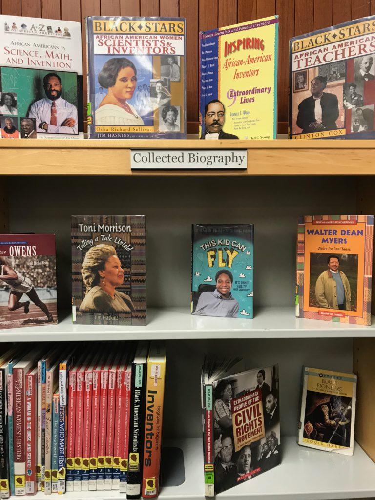 Three shelves of biographies, including books about African-American scientists, teachers, and inventors and people of the Civil Rights Movement.