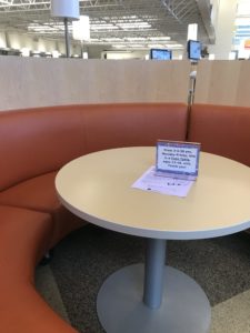 Round booth with sign for times for teen-only seating